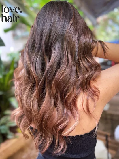 A closer look at the blush balayage, showing the delicate blend of rose gold tones into the brunette base.