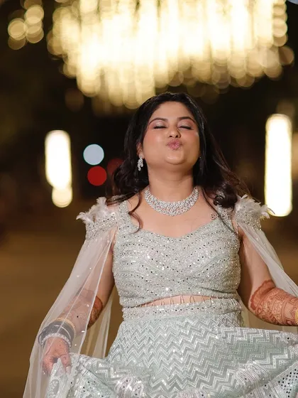 A fun and playful shot from the sangeet night. The makeup looks fresh and vibrant, even in a candid moment.