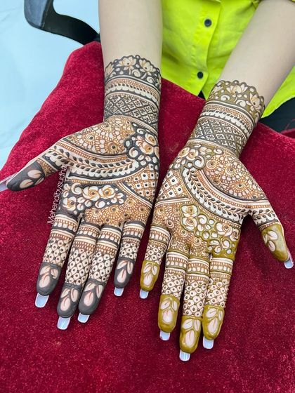 A full view of the engagement mehendi, showing how the design flows from the fingers up to the wrist.