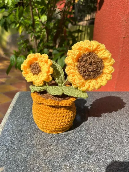 Another look at our handmade crochet sunflower pot. The bright yellow flowers are sure to add a cheerful touch to any room.