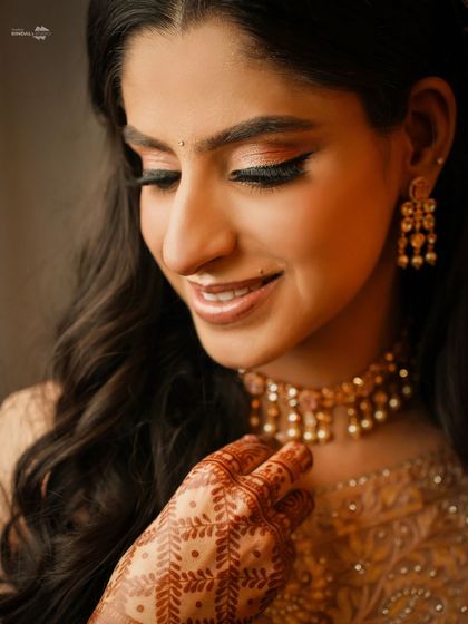 A detailed close-up of the bride's makeup, jewelry, and henna. This shot is all about capturing the fine details that make a bridal look so special.