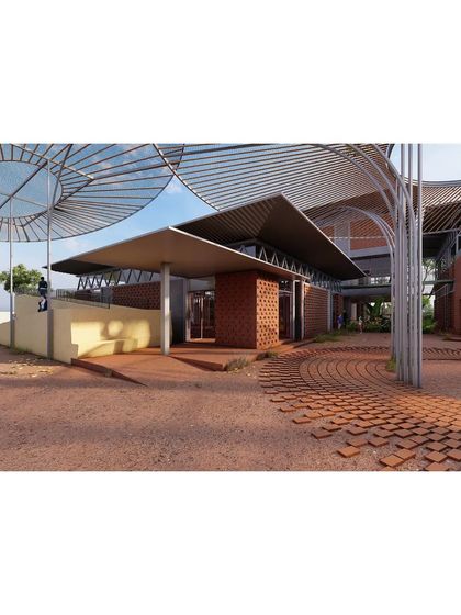 The main entry pod of The Atelier, designed with a large, welcoming overhang and accessible ramps. The use of earthy, pigmented cement and brick creates a warm and grounded entrance that invites students and visitors inside.