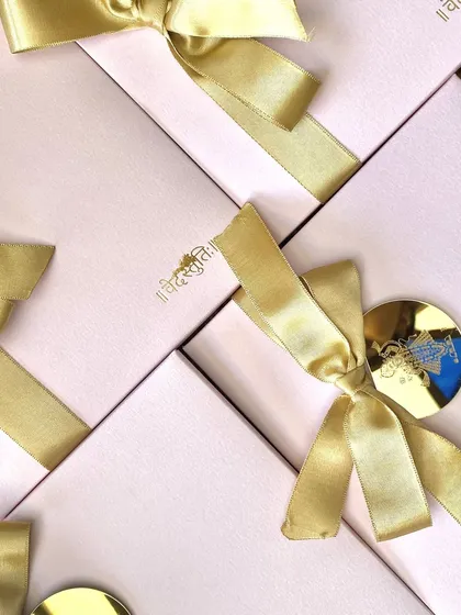 Nothing says luxury like a boxed invitation. This design features elegant pink boxes with custom gold foil monograms and satin ribbons, creating a truly special unboxing experience for guests.