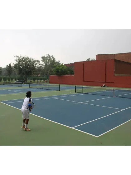 A young player in our junior program gets ready to receive a serve, learning proper court positioning and anticipation.