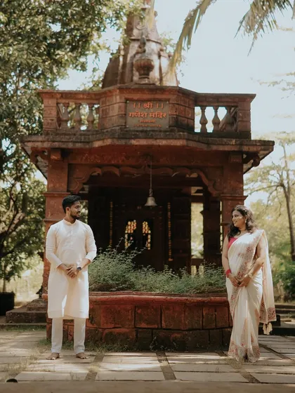A moment of quiet connection in front of a beautiful, traditional temple in Alibaug. This pre-wedding shot blends love with a sense of divine blessing.