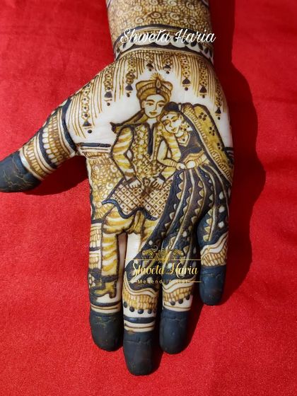 A close-up of a traditional couple portrait, showcasing the detail in the bride and groom's attire and expressions.