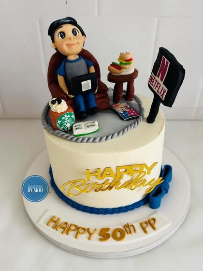 Cheers to 50 fabulous years! This rich chocolate and coffee ganache cake was designed to tell the story of the birthday person's life and hobbies.