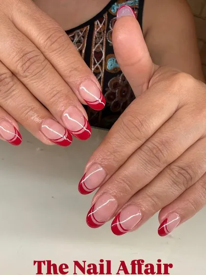 A modern twist on a classic. This double French manicure uses a bold red and clean white lines on a natural base for a chic and sophisticated look.
