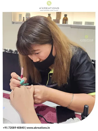 Here is one of my talented nail artists, Asemraleng, carefully hand-painting a detailed design. I believe in precision and artistry in every service we provide.