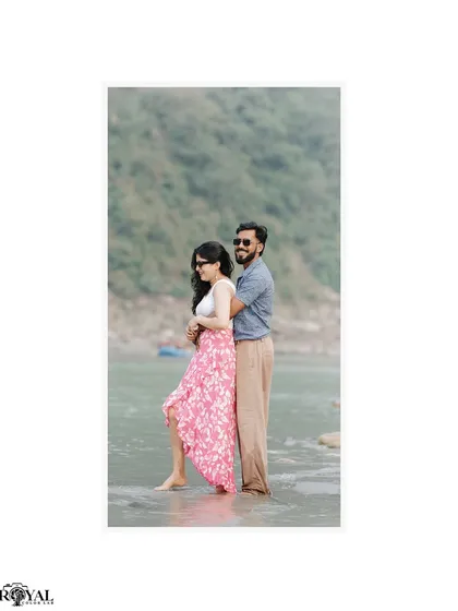 A simple, elegant portrait of a couple embracing by the river, with the focus on their connection.