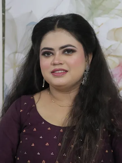 A classic portrait of the finished party look. The makeup enhances her features without being overpowering, perfect for any special occasion.