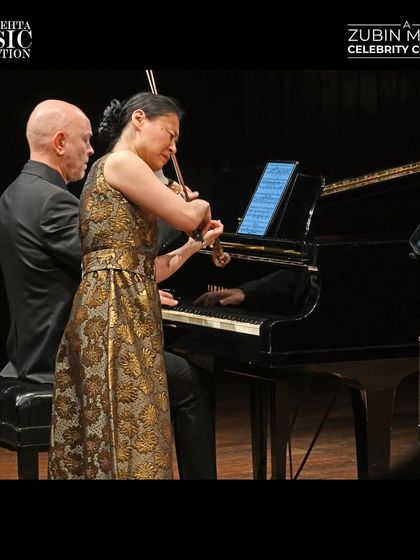 A dynamic performance shot of violinist Midori and pianist Özgür Aydın at the Zubin Mehta Celebrity Concert, capturing their seamless musical partnership.