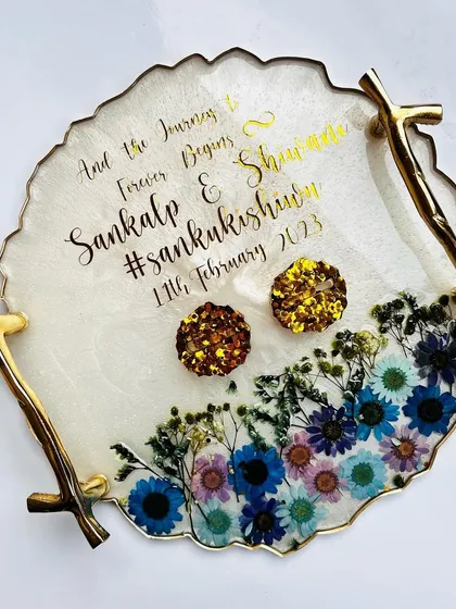 Another view of the pressed flower tray, showing the elegant gold branch handles and personalized text.