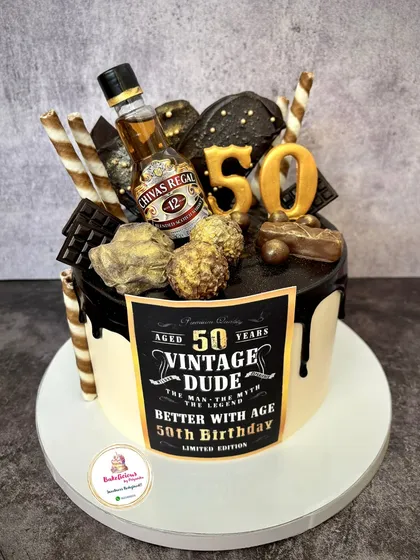 For the "Vintage Dude" turning 50, this cake was all about indulgence. It's a rich chocolate cake loaded with more chocolates, wafers, and gold accents, topped with a miniature Chivas Regal bottle to celebrate a milestone in style.