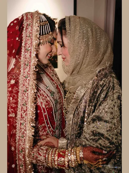 A heartfelt moment between the bride and her mother. The shared smile and gentle touch convey a lifetime of love and blessings for the new journey ahead.