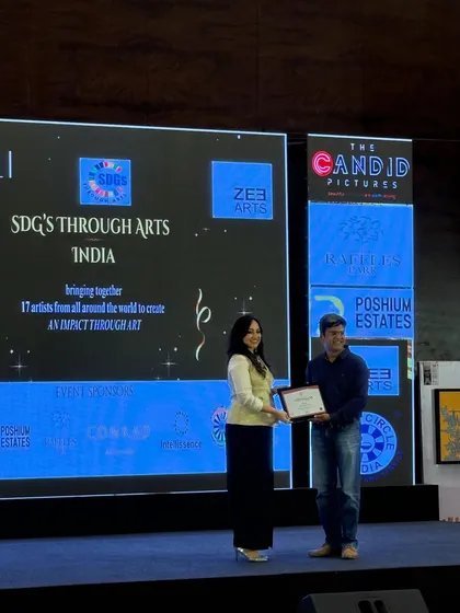 Receiving a certificate of participation at the 'SDGs Through Arts' event. Being recognized on stage for my contribution to this impact-driven art project was a deeply humbling and encouraging experience.