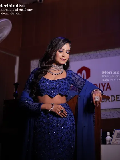 This elegant look in a deep blue lehenga is perfect for a reception or sangeet night. The makeup is kept sophisticated to balance the heavy embroidery.