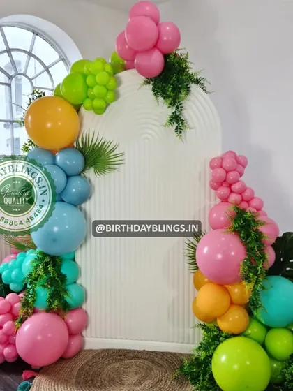 A vibrant and tropical balloon arrangement with lush greenery, perfect for adding a splash of color to any event.