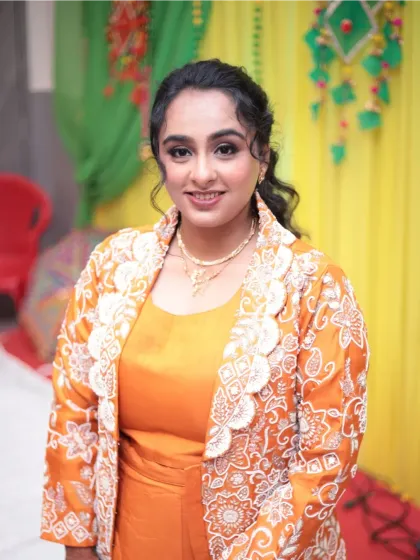 A happy, smiling portrait of the bride at her Mayera ceremony. The natural makeup look enhances her features without overpowering her traditional outfit.