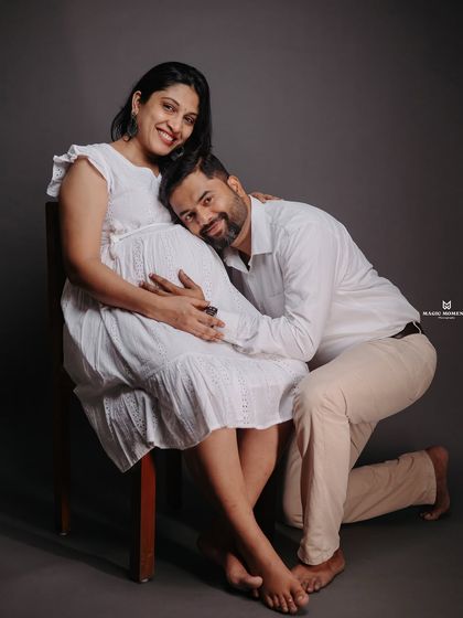 An intimate and loving pose in the studio. The partner kneeling to listen to the baby bump is a classic shot that I love to capture for its emotional impact.