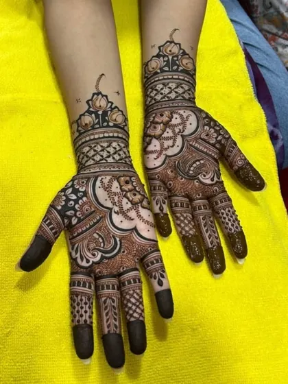 A beautiful fusion design with lotus motifs at the wrist and a mix of traditional and modern patterns on the palm and fingers.