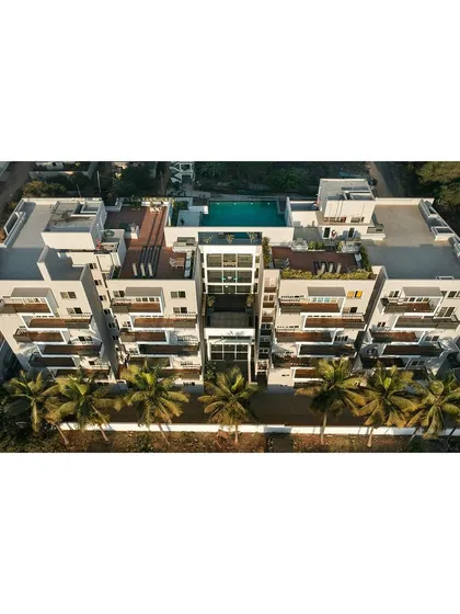 An aerial view of "The Treehouse" housing project in Bengaluru reveals our strategy for community living. We dismantled the traditional clubhouse, distributing social and activity spaces vertically throughout the building's core, from the ground-floor lobby to the rooftop pool.