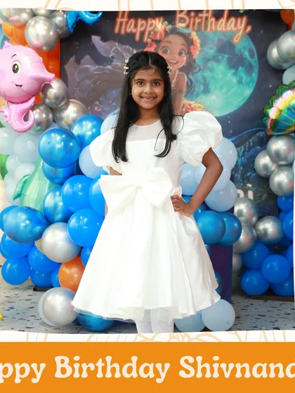 Happy Birthday, Shivanandini. The birthday girl looking radiant in front of her party backdrop.