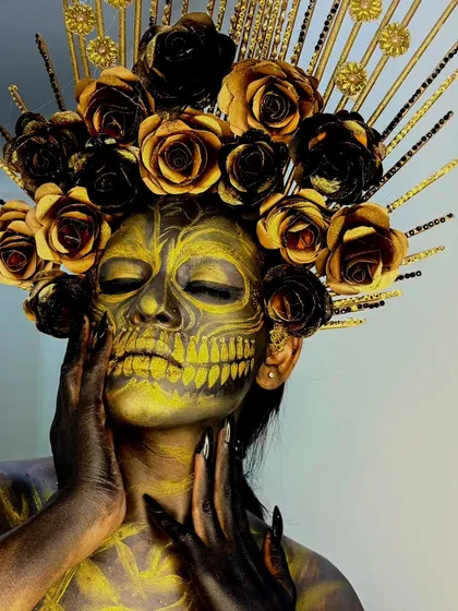 A close-up on the golden skull makeup. The intricate details and shading create a 3D effect, a testament to the advanced techniques taught at our academy.