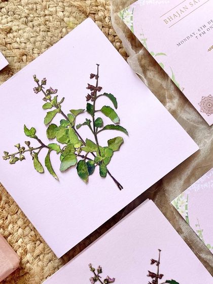 A close-up of the hand-appliquéd Tulsi cutout. This three-dimensional element adds a unique, tactile quality to the invitation, making it stand out.