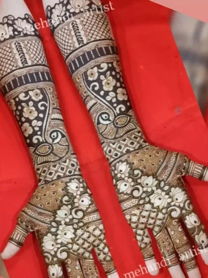 A gorgeous bridal design with repeating peacock motifs on the arms and a floral jaal on the palms. The use of negative space makes the peacocks stand out.