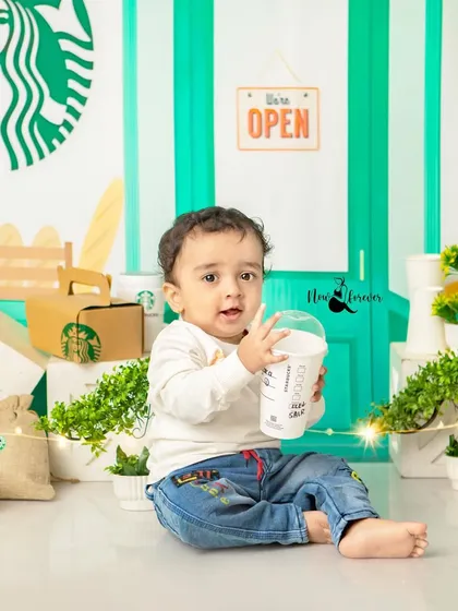 Enjoying his very own baby-friendly Frappuccino. The props are all carefully selected to be safe and fun for the little ones.