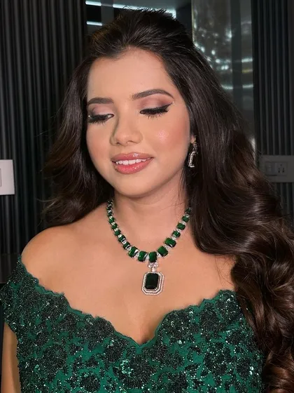 The side profile highlights the elegant design of the earrings and the intricate setting of the stones.