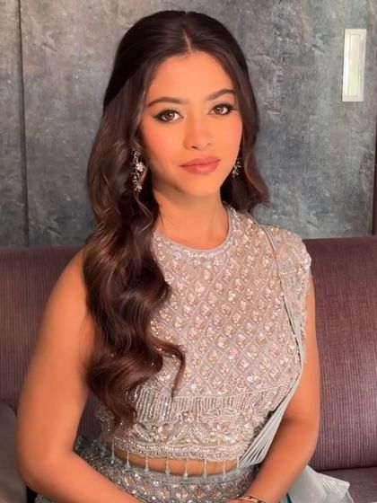 A close-up of a client in our powder blue lehenga. The sleeveless design and intricate beadwork on the blouse are perfect for a summer wedding event.