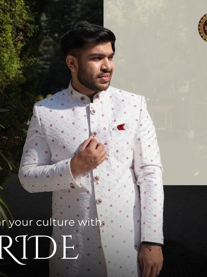Wear your culture with pride. This white sherwani with red detailing is a celebration of heritage, designed for the groom who wants to honor his roots.