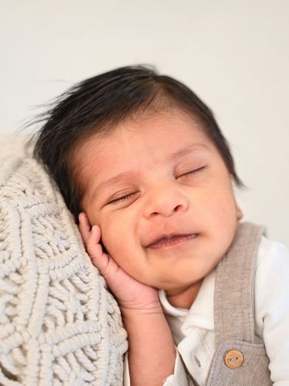 That happy, dreamy smile is everything. By using simple outfits and textures, I can create portraits that highlight your baby's joyful expressions.