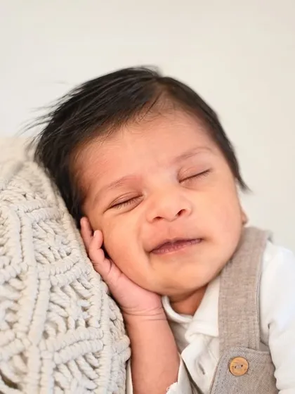 That happy, dreamy smile is everything. By using simple outfits and textures, I can create portraits that highlight your baby's joyful expressions.