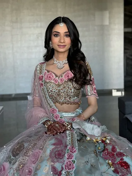 The definition of soft elegance. For this bride, I focused on a clean, dewy base and gentle pink tones on the eyes and lips to perfectly match her beautiful floral lehenga. It's a timeless and romantic bridal style.