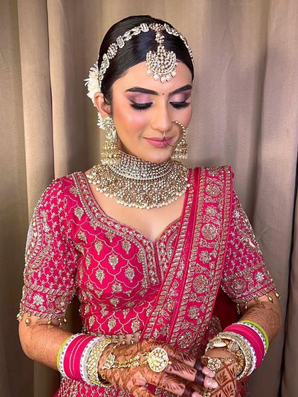 A beautiful shot of this bride's makeup. The soft pink tones on her eyes and lips, paired with a radiant complexion, create a look of pure elegance.