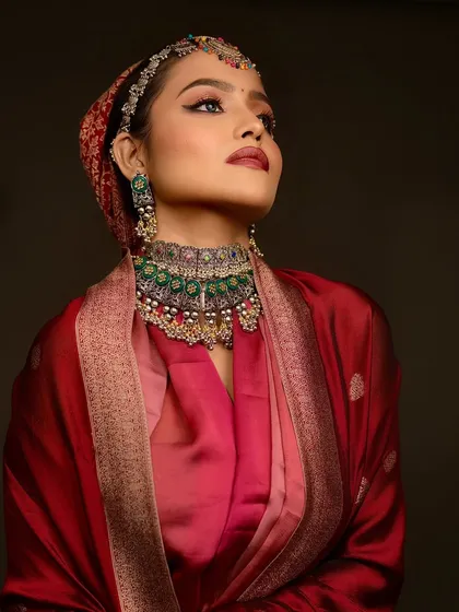 A more artistic pose, showing the flow of the saree and the intricate headpiece.