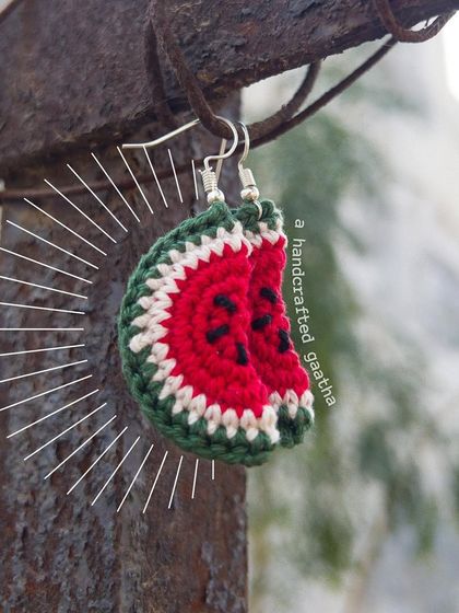 A styled product shot of the watermelon earrings. They are the ultimate summer accessory, full of quirky charm.