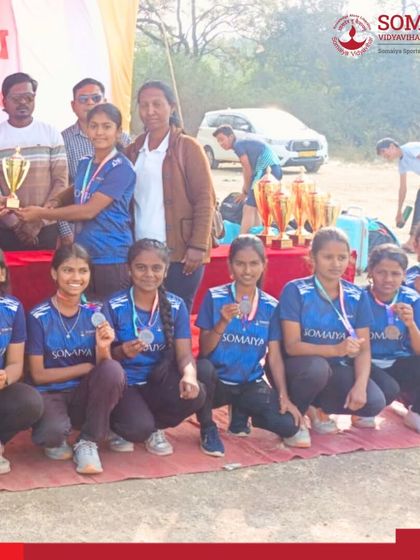 The U-17 girls' tennis cricket team receives their third-place trophy at the state-level championship, a testament to their hard work and the success of our rural sports initiatives.