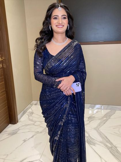 Saloni looking elegant and poised for her engagement. We opted for a very simple and subtle makeup look to go with her stunning navy blue sequin saree.