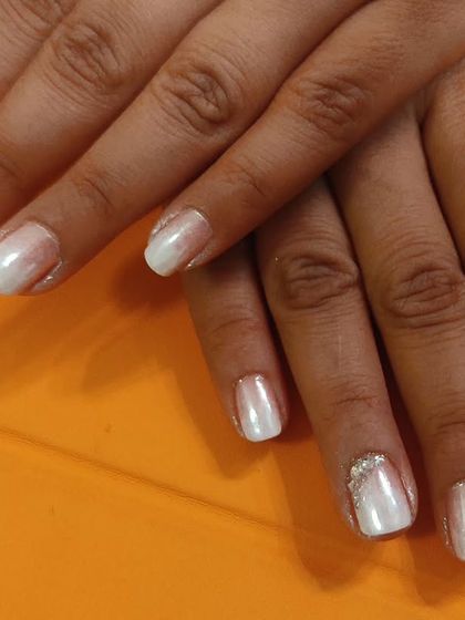 A clean and bright look using a pearly white polish. I added a simple band of silver glitter at the base of the ring finger nails for a touch of sparkle.