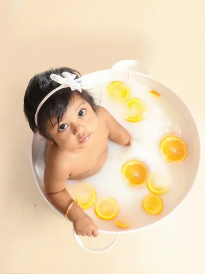 A sweet milk bath session. The simple white tub and floating orange slices create such a fresh and pure look.
