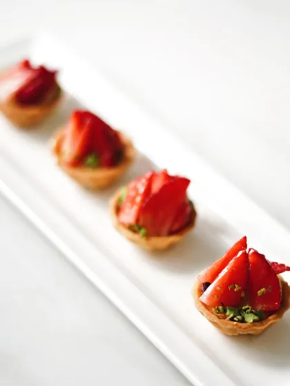 Bite-sized strawberry tartlets, ideal for parties and events. These mini treats offer the same delicious flavor in a convenient, shareable format.
