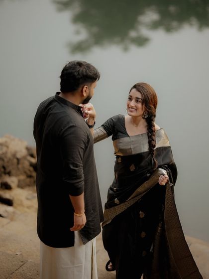 A gentle, playful interaction by the water's edge. I focus on capturing the subtle gestures that reveal a couple's unique bond during their pre-wedding shoot.