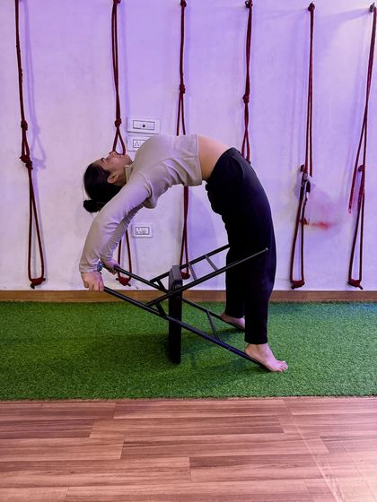 Looking up and opening the heart. The chair provides a stable base to push against, enhancing the backbend.