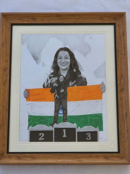 The finished piece in a handsome wooden frame, which complements the colors of the flag.