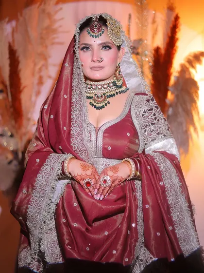 The complete royal bride pose. Notice how the makeup, jewelry, and outfit all come together to create a cohesive and stunning final look.