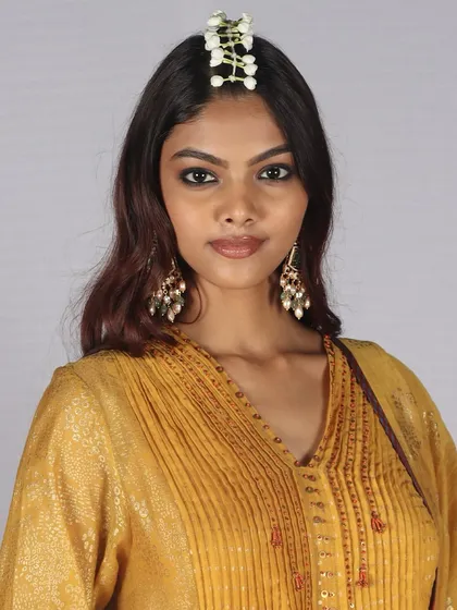 The Look of the Day from Bombay Times Fashion Week, featuring a soft kohl-rimmed eye and fresh floral hair accessory. Our artists master the art of subtle yet impactful runway beauty.